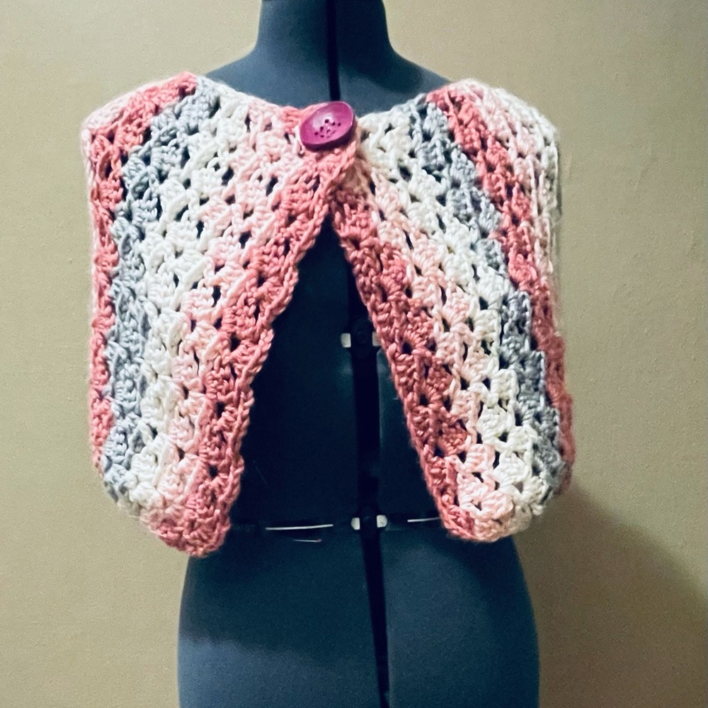 Handcrafted spring off the shoulder button shawl.